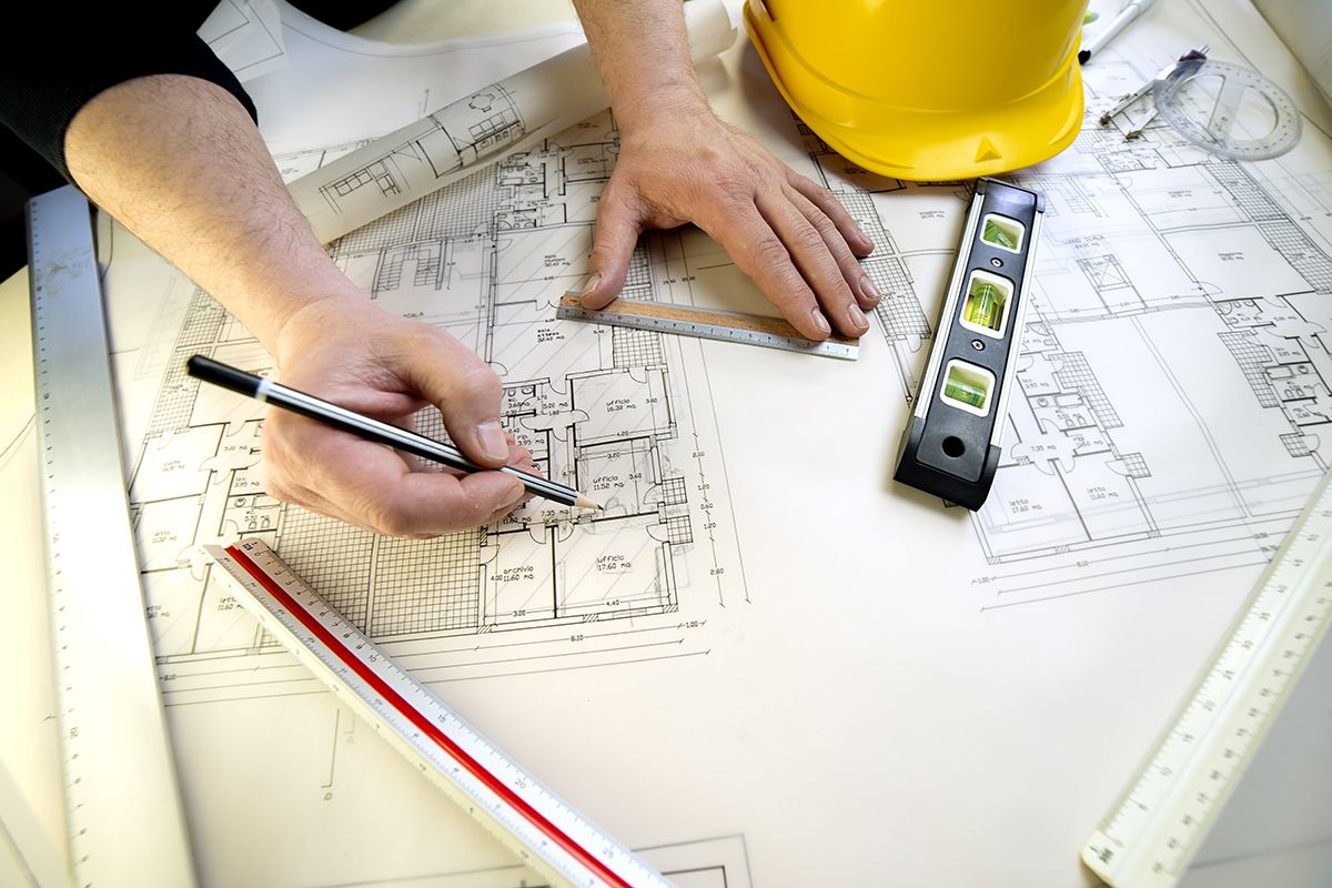 Builder Reviewing Detailed Construction Drawings